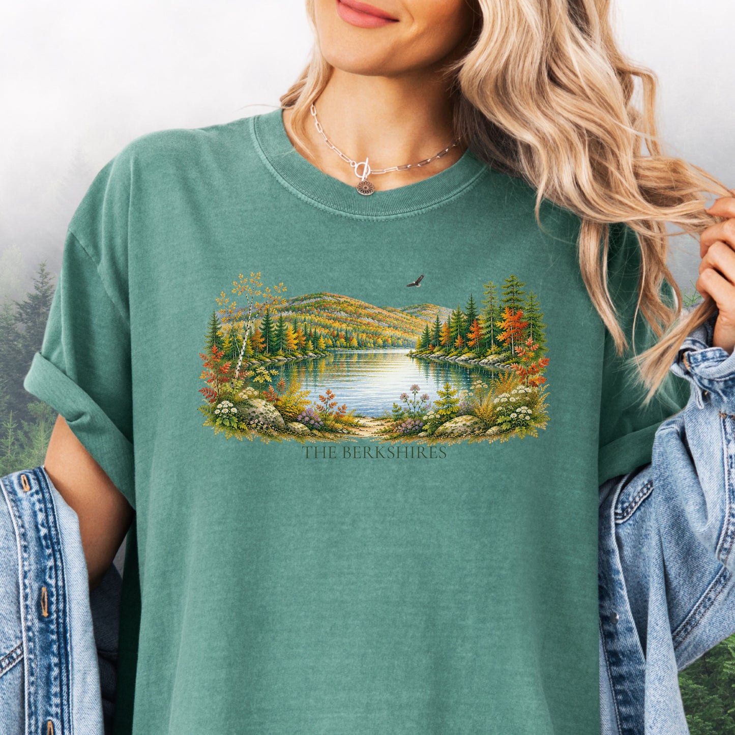 Person wearing The Berkshires autumn landscape Comfort Colors T-shirt with colorful fall foliage, mountains, lake and eagle in the color light green.