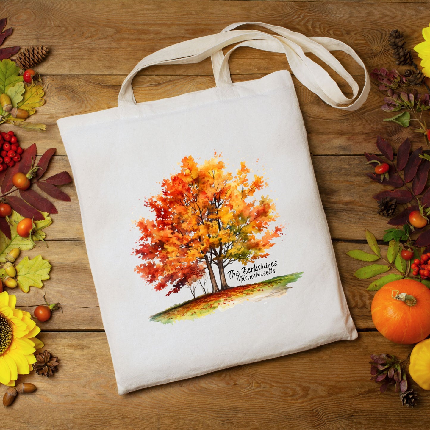 Flat lay of a cotton tote bag with a watercolor maple tree design and the text “The Berkshires Massachusetts” printed on the front.