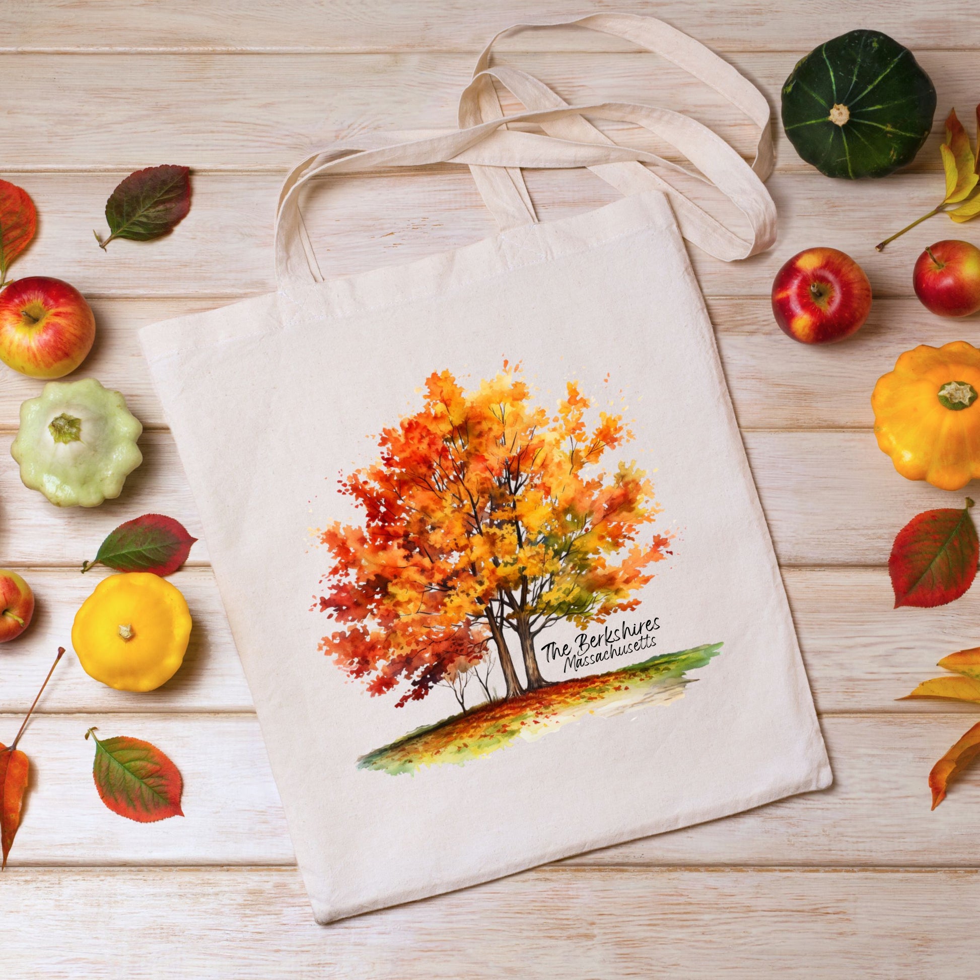 Flat lay of a cotton tote bag with a watercolor maple tree design and the text “The Berkshires Massachusetts” printed on the front
