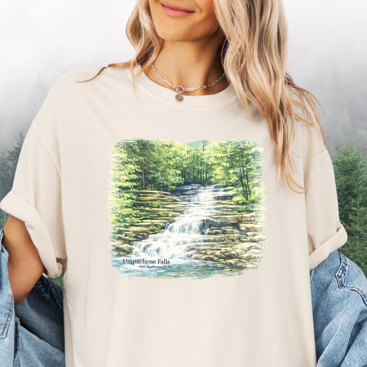 Person wearing Umpachene Falls Comfort Colors t-shirt with waterfall design in ivory