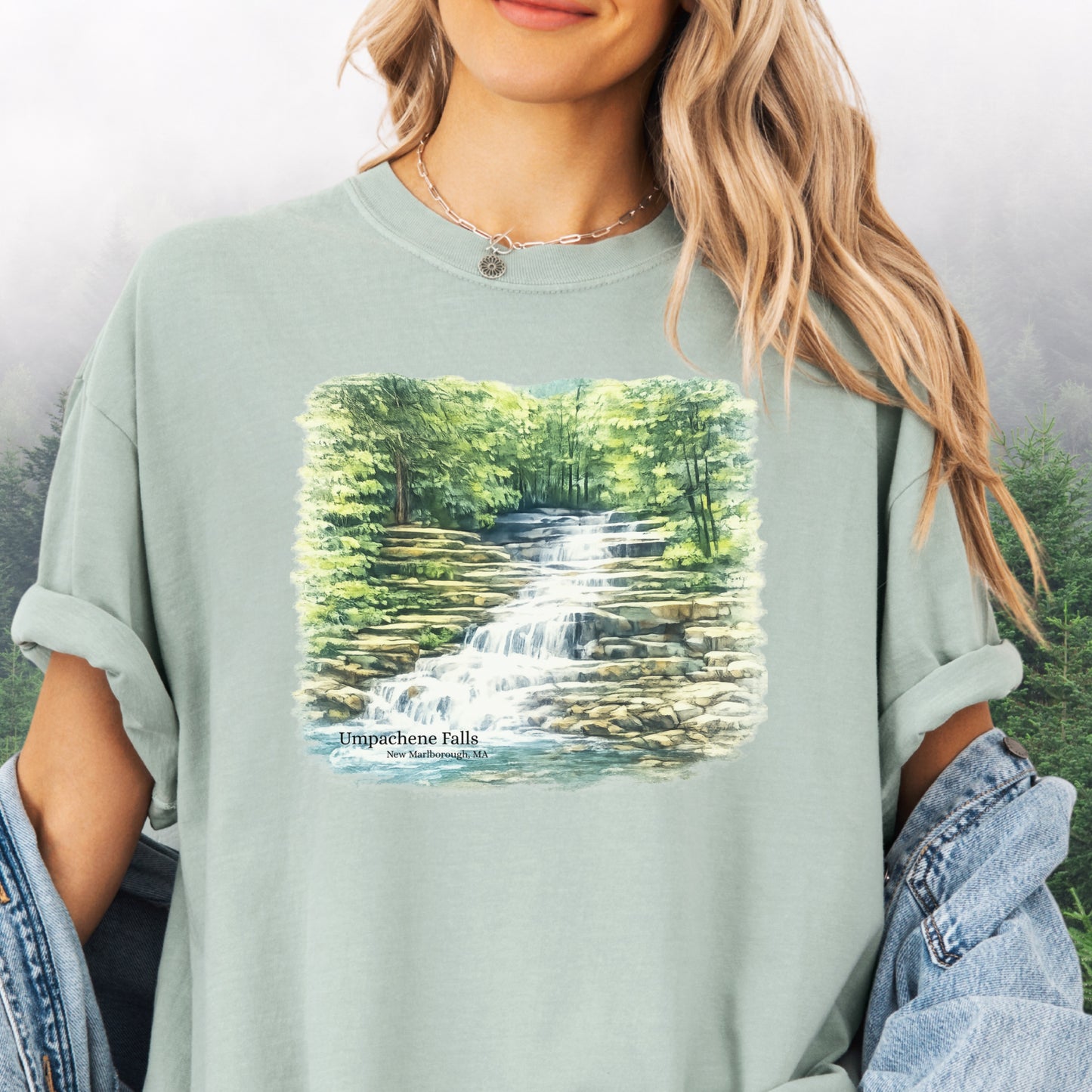 Person wearing Umpachene Falls Comfort Colors t-shirt with waterfall design in the color bay