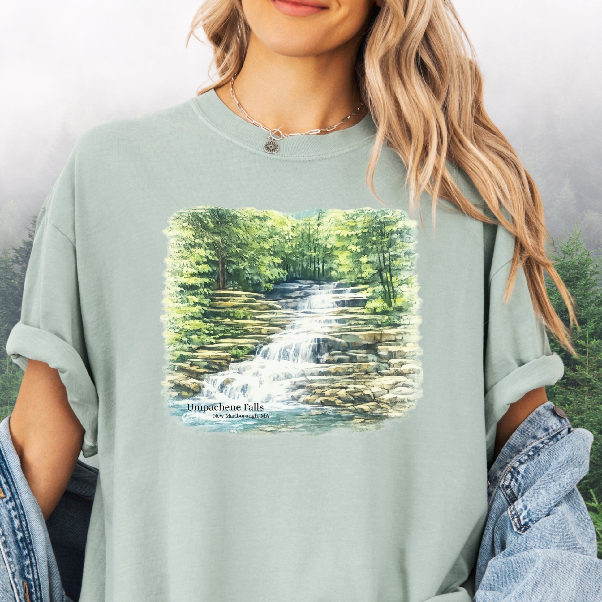 Person wearing Umpachene Falls Comfort Colors t-shirt with waterfall design in the color bay